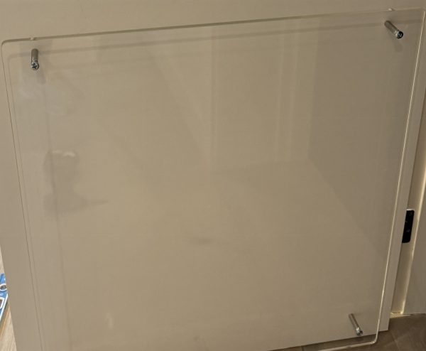 Flat elevator door space panel installed to reduce door-to-hoistway clearance