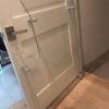 Standard 33-inch left-hand acrylic elevator door baffle installed on residential elevator landing door